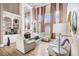 Cozy living room with fireplace, built in shelves and tall windows with flowing curtains at 461 Wynns Way, Atlanta, GA 30331