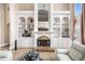 A well-lit living room featuring a fireplace, built in shelves and hardwood floors at 461 Wynns Way, Atlanta, GA 30331