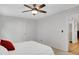 Bright bedroom with neutral walls, ceiling fan, and open door to another room at 615 Spruce Dr, Pine Lake, GA 30072