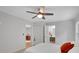 Bright bedroom with neutral walls, ceiling fan, and ensuite bathroom at 615 Spruce Dr, Pine Lake, GA 30072