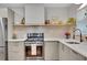 Well-appointed kitchen features quartz countertops, floating shelves, and stainless steel appliances at 615 Spruce Dr, Pine Lake, GA 30072