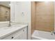 Bathroom featuring a shower and tub combo, updated vanity, and neutral tiling at 1908 Variations Ne Dr, Atlanta, GA 30329