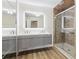 Bathroom featuring double sinks, a large mirror and a glass enclosed shower at 1908 Variations Ne Dr, Atlanta, GA 30329
