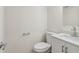 Modern powder room features a new white vanity, mirror and toilet at 1908 Variations Ne Dr, Atlanta, GA 30329