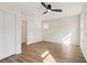 Bright bedroom featuring wood-look floors, a modern ceiling fan, and a closet at 1908 Variations Ne Dr, Atlanta, GA 30329