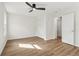 Bright bedroom features hardwood floors, a ceiling fan and white closet at 1908 Variations Ne Dr, Atlanta, GA 30329