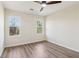 A vacant bedroom with wood laminate floors and bright, natural light from two windows at 1908 Variations Ne Dr, Atlanta, GA 30329