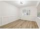 Open-concept dining room with wainscoting and hardwood flooring at 1908 Variations Ne Dr, Atlanta, GA 30329