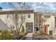 Attractive townhome featuring well-maintained landscaping, a concrete walkway, and a pleasing color scheme at 1908 Variations Ne Dr, Atlanta, GA 30329