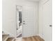 Bright foyer with light hardwood flooring, white front door with sidelight, and coat closet at 1908 Variations Ne Dr, Atlanta, GA 30329