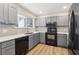 Well-lit kitchen features gray cabinetry, modern appliances, quartz countertops, and hardwood flooring at 1908 Variations Ne Dr, Atlanta, GA 30329