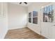Inviting sunroom featuring hardwood floors, natural light and a charming view to the outdoor greenery at 1908 Variations Ne Dr, Atlanta, GA 30329
