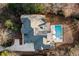 Birds eye view of the property showcasing the home, pool, mature trees, and expansive lot at 5060 Lake Forrest Dr, Atlanta, GA 30342
