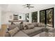 Finished basement with gray sectional, billiards table, and walkout to the yard at 5060 Lake Forrest Dr, Atlanta, GA 30342