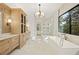 Luxurious bathroom featuring marble floors, soaking tub, and a glass enclosed shower at 5060 Lake Forrest Dr, Atlanta, GA 30342