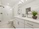 Bathroom featuring a frameless glass shower, white cabinets, and quartz countertops at 5060 Lake Forrest Dr, Atlanta, GA 30342