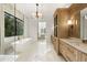 Well-lit bathroom features a spacious shower, soaking tub, and custom wooden cabinets at 5060 Lake Forrest Dr, Atlanta, GA 30342