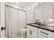 Chic bathroom features a shower, vanity, and contrasting black and white tile at 5060 Lake Forrest Dr, Atlanta, GA 30342