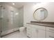 Bathroom features a glass shower, tiled floors, vanity, and modern fixtures at 5060 Lake Forrest Dr, Atlanta, GA 30342