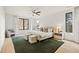 Main bedroom suite with large windows, a ceiling fan, neutral decor, and a green area rug at 5060 Lake Forrest Dr, Atlanta, GA 30342
