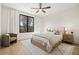 Bedroom with a ceiling fan, light hardwood floors, and view from the window at 5060 Lake Forrest Dr, Atlanta, GA 30342