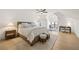 Spacious bedroom with hardwood floors, ceiling fan, area rug, and attached sitting area at 5060 Lake Forrest Dr, Atlanta, GA 30342