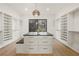 Walk-in closet featuring custom shelving, drawers, and large center island with seating at 5060 Lake Forrest Dr, Atlanta, GA 30342