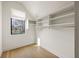 Walk-in closet with window and built-in shelving for ample storage at 5060 Lake Forrest Dr, Atlanta, GA 30342