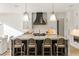 Modern kitchen with oversized marble island, pendant lighting, and seating for four at 5060 Lake Forrest Dr, Atlanta, GA 30342