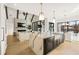 Open kitchen to living room with marble island, stainless steel appliances, and white cabinets at 5060 Lake Forrest Dr, Atlanta, GA 30342