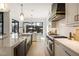Gourmet kitchen featuring marble island, stainless steel appliances and a sunlit view to the pool at 5060 Lake Forrest Dr, Atlanta, GA 30342