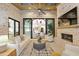 Living room with exposed brick, fireplace, vaulted wood ceilings, and sliding doors to the outdoors at 5060 Lake Forrest Dr, Atlanta, GA 30342