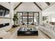 Open living area with a view of the outdoor pool, fireplace, and modern finishes at 5060 Lake Forrest Dr, Atlanta, GA 30342
