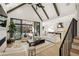 Open-concept living room with a view of the patio, pool, and a modern white kitchen at 5060 Lake Forrest Dr, Atlanta, GA 30342