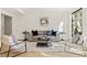 Cozy living room with modern decor, comfortable seating, and lots of light from the windows at 5060 Lake Forrest Dr, Atlanta, GA 30342
