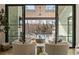 Bright living room with large sliding doors leading to covered outdoor space with pool view at 5060 Lake Forrest Dr, Atlanta, GA 30342