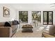 Comfortable living room featuring large windows with views and stylish decor at 5060 Lake Forrest Dr, Atlanta, GA 30342