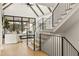 Stylish staircase adjacent to a bright living room with vaulted ceilings and modern finishes at 5060 Lake Forrest Dr, Atlanta, GA 30342