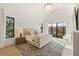 Bright main bedroom with high ceilings, plush rug, neutral decor, and windows with leafy views at 5060 Lake Forrest Dr, Atlanta, GA 30342
