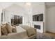 Bright main bedroom featuring a fireplace, large window, and modern decor at 5060 Lake Forrest Dr, Atlanta, GA 30342
