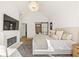 Bright main bedroom with vaulted ceiling, modern lighting, and sleek fireplace at 5060 Lake Forrest Dr, Atlanta, GA 30342