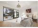 Bright main bedroom with pool view, modern art, and plush neutral colored bedding at 5060 Lake Forrest Dr, Atlanta, GA 30342