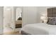 Bedroom featuring an ensuite bathroom, a padded headboard, and decorative pillows at 5060 Lake Forrest Dr, Atlanta, GA 30342