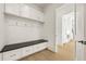 Mudroom with built-in storage, drawers, a bench, and hooks for organization at 5060 Lake Forrest Dr, Atlanta, GA 30342