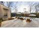 Backyard pool with sun loungers, umbrellas, an outdoor grill, and a wooded surrounding landscape at 5060 Lake Forrest Dr, Atlanta, GA 30342