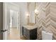 Well-lit powder room with a distinctive accent wall, gold fixtures, and a black vanity at 5060 Lake Forrest Dr, Atlanta, GA 30342