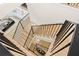 Elegant staircase with light wood steps and dark metal railings leading to the bright living area at 5060 Lake Forrest Dr, Atlanta, GA 30342