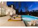 Inviting backyard pool with lounge chairs and outdoor grill, perfect for entertaining and relaxation at 5060 Lake Forrest Dr, Atlanta, GA 30342