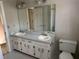 Bathroom featuring a double sink vanity and tub/shower combination at 6420 Phillips Pl, Lithonia, GA 30058