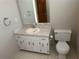 Cozy bathroom featuring a single vanity, large mirror, and toilet at 6420 Phillips Pl, Lithonia, GA 30058